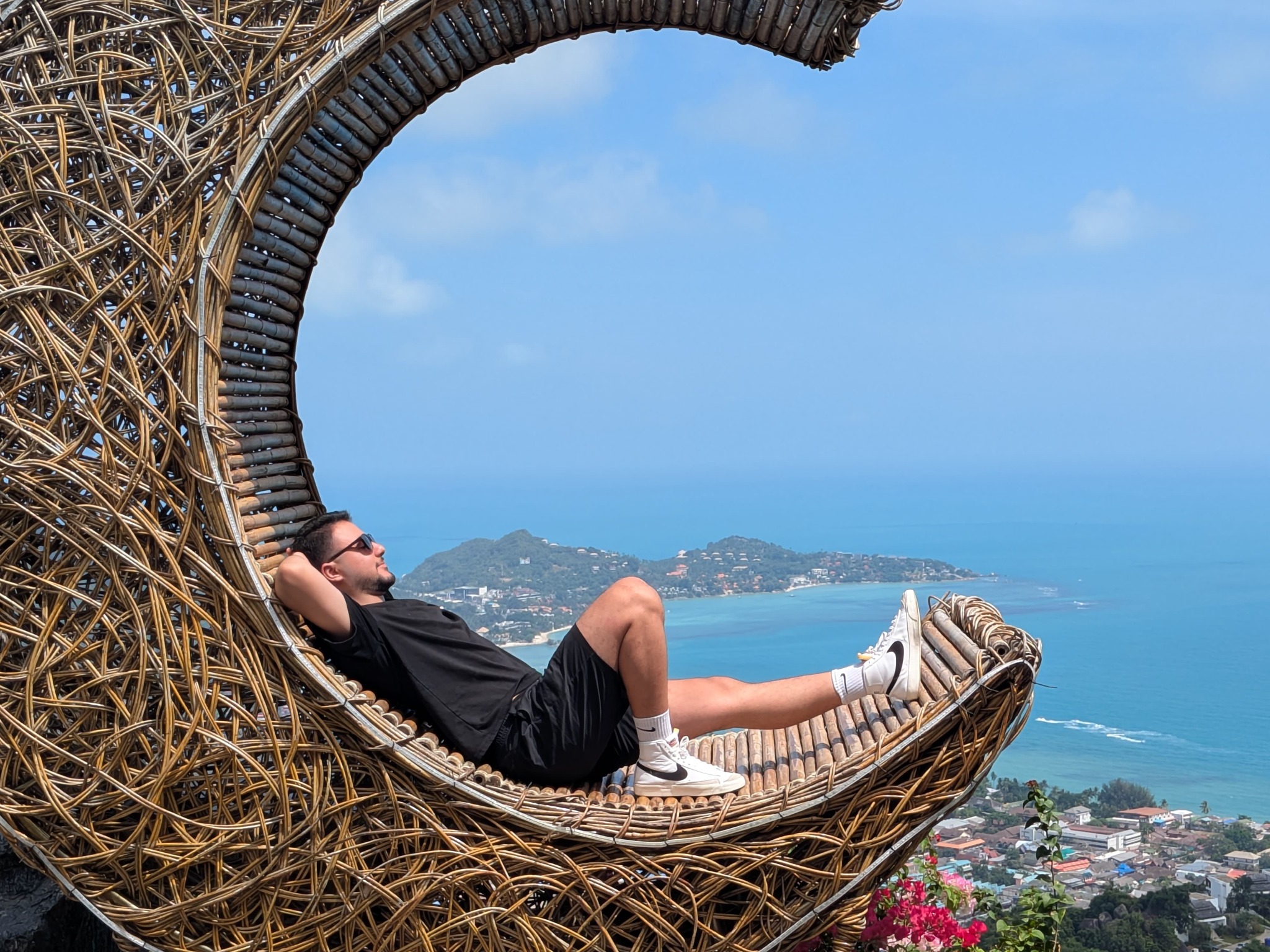 Mo relaxing in a woven lookout above the sea in Koh Samui, Thailand.
